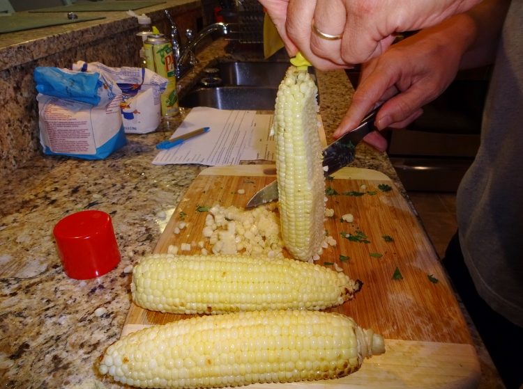 Use a cob holder to control the corn as you slice off the kernels